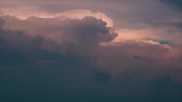 Dramatic storm clouds moving in reverse 4k timelapse evening sky