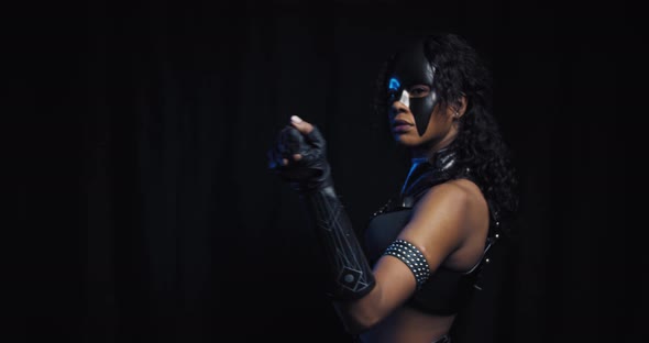 Cute Young Woman in Black Mask and Leather Clothes Is Posing Sexy Lady alt