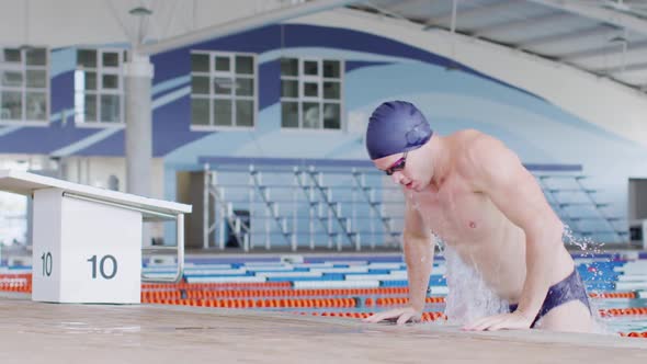 Swimmer coming out of pool alt