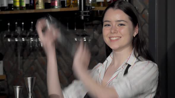Cheerful Female Bartender Preparing a Drink for a Customer alt