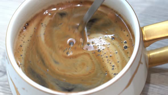 Pieces Of Instant Coffee Fall From The Spoon Into the Cup