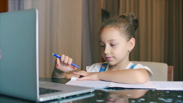 Little Girl a Cute Elementary School Child of 7-8 Years Old at Home Studying in Family Learning alt