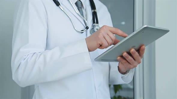 Doctor In Hospital Using Digital Tablet alt