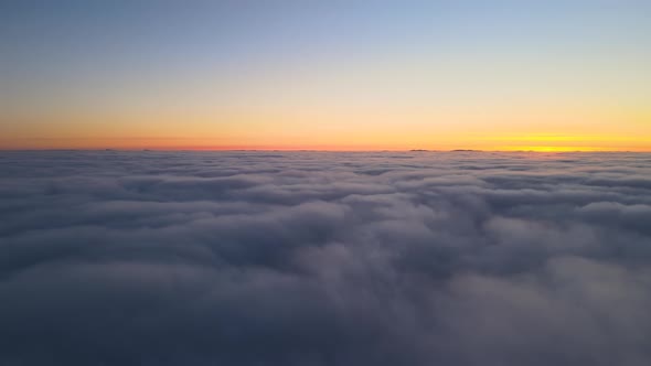 Aerial View From Airplane Window at High Altitude of Dense Puffy Cumulus Clouds Flying in Evening alt