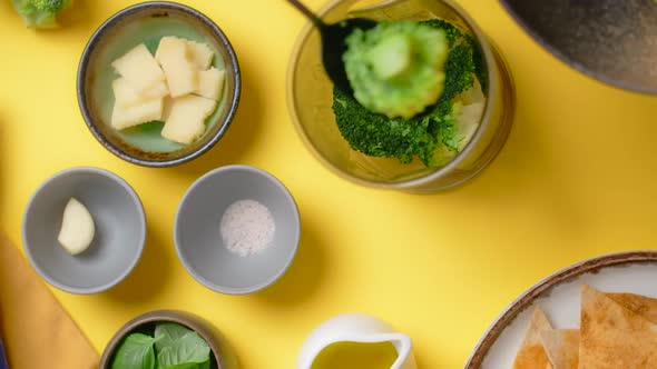 Vertical Flat Lay Video Chef Adds Broccoli to the Blender Bowl Cooking with Vegetables and Healthy