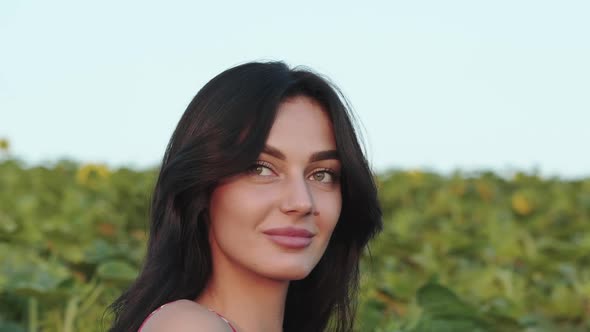 Pretty Brunette Looks at the Sky and Rejoices From Correcting Her Long Hair alt