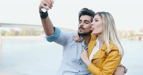 Happy Cheerful Couple Taking Selfies and Smiling