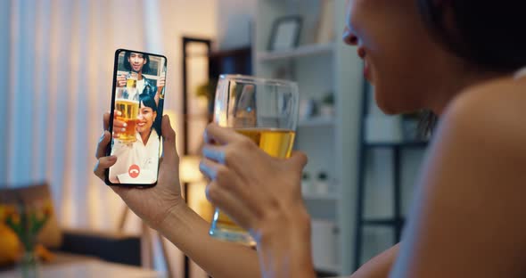 Asia female drinking beer having fun happy moment night party event online celebration via video.