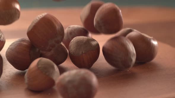 Hazelnuts falling onto wooden surface in super slow motion.  Shot on Phantom Flex 4K high speed came