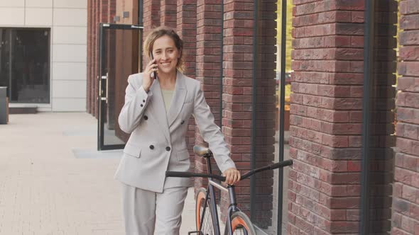 Active Business Woman Talking on Phone Outdoors alt