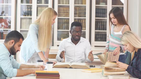 Group of Young Students Doing School Assignment in Library alt