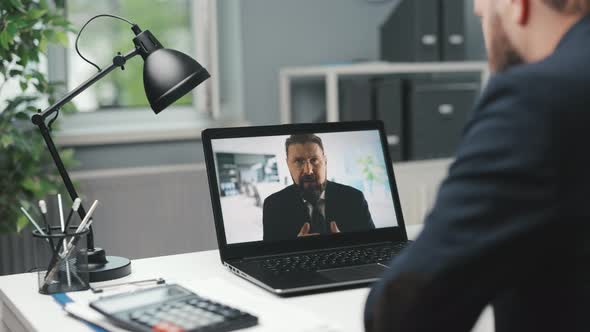 Businessman Having Videochat on Laptop