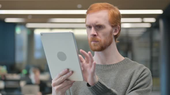 Portrait of Attractive Young Man Using Tablet in Office alt