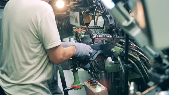Factory Worker Is Processing a Sole of a New Shoe alt