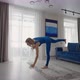 Young Woman Meditating Sitting on Carpet and Doing Splits Stretching Doing Yoga Blue Sportswear - VideoHive Item for Sale