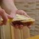 Commercial Footage a Young Girl Cuts Bread with a Knife Spreads a Sandwich with Butter and Pours - VideoHive Item for Sale