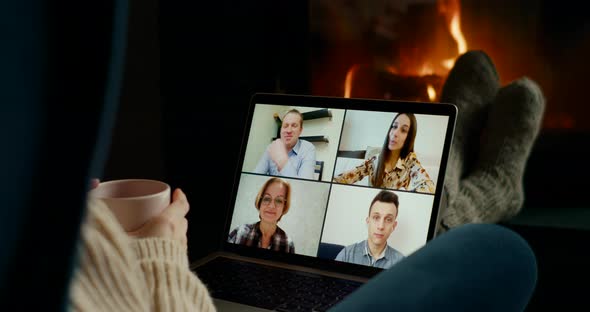Online Group Video Call of Work Team Meeting or Friends on Laptop at Fireplace