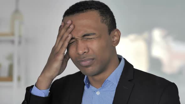 Headache Portrait of Tense Casual AfroAmerican Businessman in Office alt