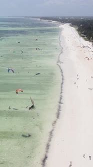 Vertical Video Kitesurfing Near the Shore of Zanzibar Tanzania alt