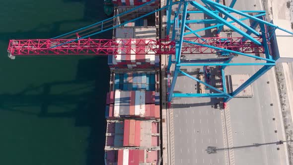 Drone Flying Over a Container Ship During Cargo Operations Over the Customs Area alt