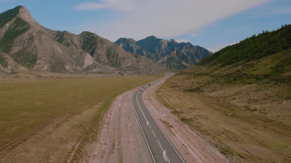 Chuya highway in mountains valley of Altai with traffic cars