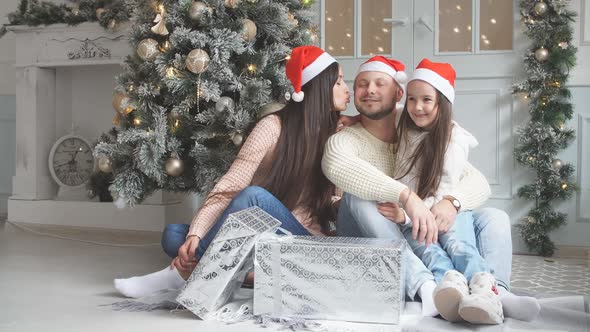 Portrait of Friendly Family in Santa Caps on Christmas