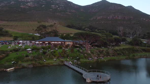 Drone shot of a vineyard in Cape Town - drone is reversing from the restaurant and outside areal. Sn alt