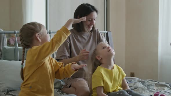 Mom Braids Her Children