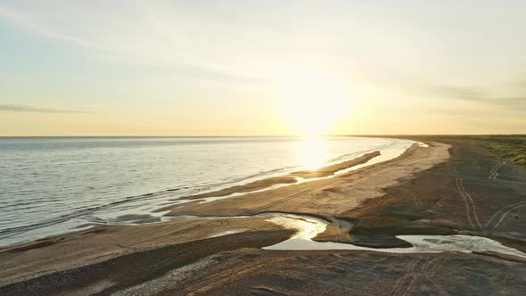 Sunlight Shining Bright and Its Reflection Seen in the Beautiful and Calm Beach Waters in Jutland alt