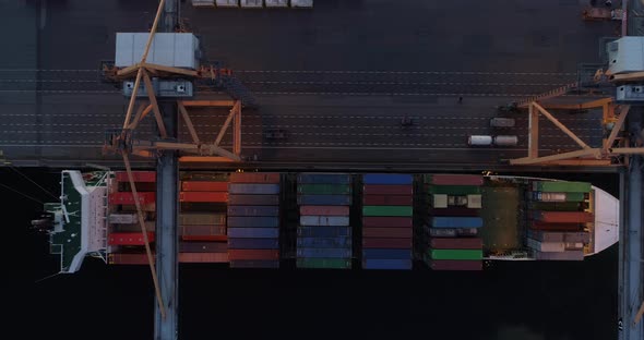 Cargo Ship Loading in Container Terminal Port Aerial Top Down View at Night alt