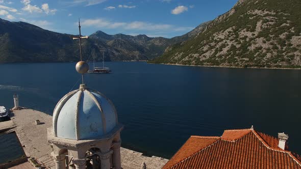Blue Roof of the Bell Tower of the Church of Our Lady in the Rocks Against the Background of the Sea alt