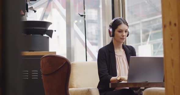 Caucasian Businesswoman Login to a Video Conference in a Coffee Shop alt