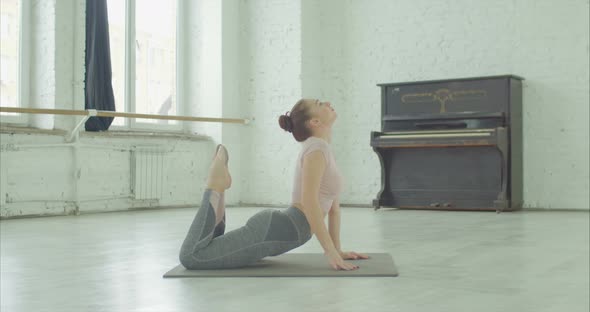 Yogi Fit Woman Doing King Cobra Exercise Indoors alt