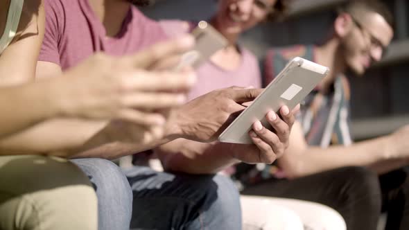 People Sitting on Wooden Bench and Using Digital Devices alt