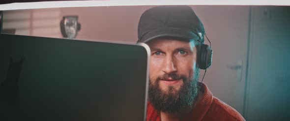 View of a man’s face working behind the computer screen alt