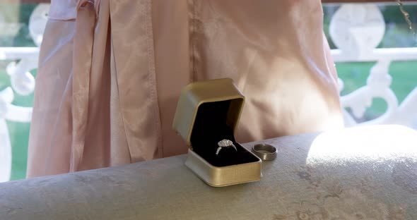 Woman keeping wedding ring and necklace on the sofa 4K 4k alt