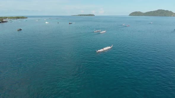 Aerial: kora-kora traditional canoe annual race in the Banda Islands Indonesia alt