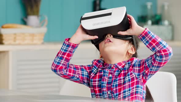 Little Asian Girl Using VR Goggles