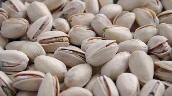 Close-up of salted unpeeled pistachios.