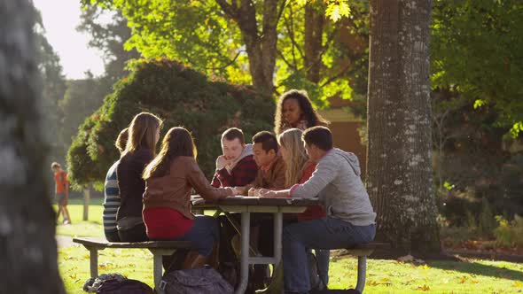 Group of college students on campus meeting outdoors