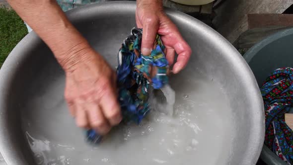 Handwash Laundry By Wrinkled Hands with Damaged Elderly Skin of 80 Years Old Woman