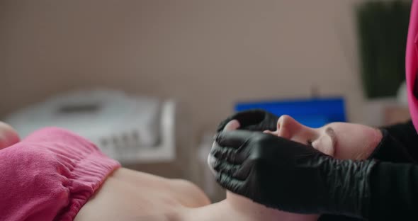 Cosmetologist Wipes a Woman's Face with Sponges Face Care at the Beauty Salon  60p Prores HQ alt