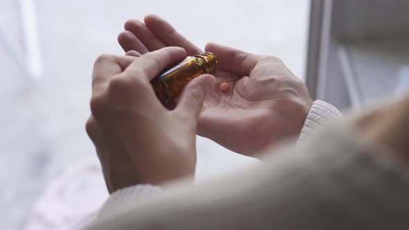 Take Antidepressants, Medicines, Capsules, Tablets At Home. Orange Pills Spilled From Brown Bottle alt