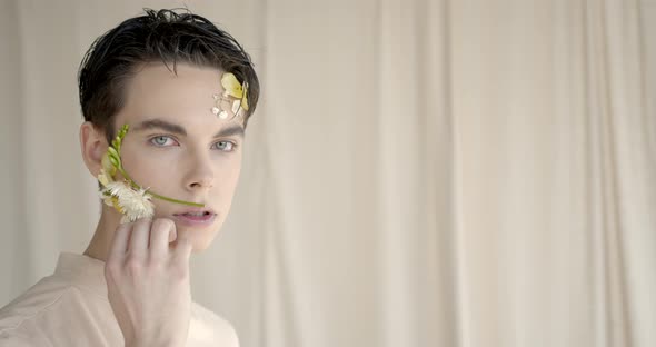 Handsome Young Man with Flowers on Face alt