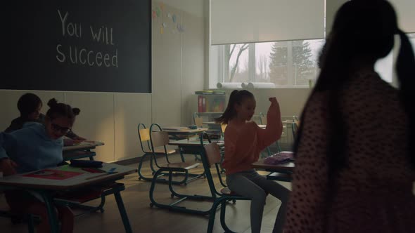 Students Walking in Classroom at School alt