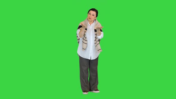 Middle Aged Woman Talking To Camera on a Green Screen, Chroma Key. alt