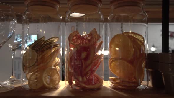 Dried fruit chips in a glass jar orange, lemon, grapefrui