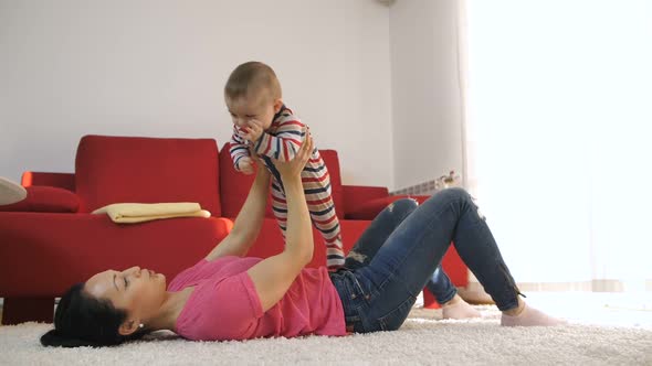 Mother Having Fun with Her Baby Son at Home alt