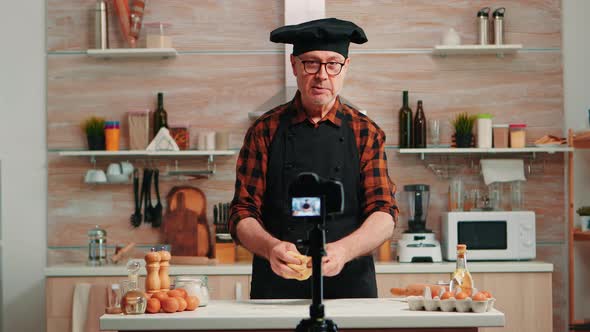 Senior Man Creating Content for Culinary Blog alt