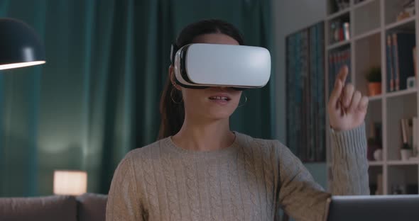Woman interacting with virtual reality and smiling